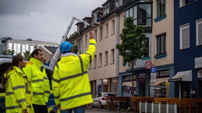 A construction consultant talks to two police officers about the damage. AP Photo