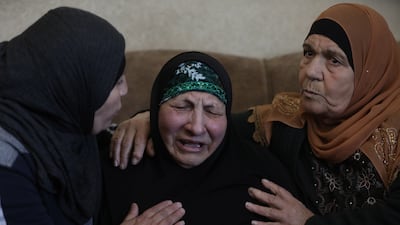Palestinians comfort the widow of Omar Asaad during his funeral in Jiljilya village, near the West Bank city of Ramallah. EPA