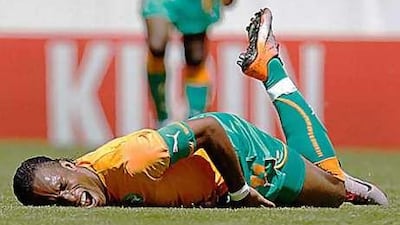 The Ivory Coast forward Didier Drogba, reacts in pain as he goes down during a friendly game against Japan at the Stade de Tourbillon in Sion.
