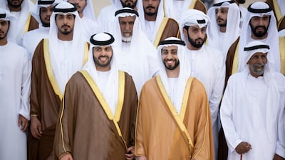 Sheikh Zayed bin Mansour bin Zayed (2nd R) and Sheikh Hazza bin Hamdan bin Zayed (3rd R) pose for a photograph during their group wedding at Qasr Al Hosn.
