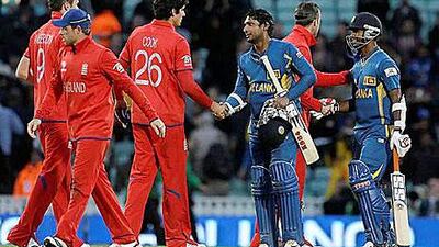 England's captain Alastair Cook, third left shakes hand with Sri Lanka's Kumar Sangakkara following their defeat. Alastair Grant / AP Photo