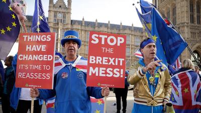 Anti-Brexit demonstrators protest outside Parliament as British PM Theresa May was attending Prime Minister's questions in London, Wednesday, Nov. 14, 2018. British Prime Minister Theresa May will try to persuade her divided Cabinet on Wednesday that they have a choice between backing a draft Brexit deal with the European Union or plunging the U.K. into political and economic uncertainty. (AP Photo/Matt Dunham)