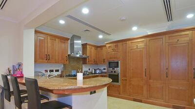 The kitchen has a breakfast bar to sit at and digest your morning cereal. Courtesy Better Homes