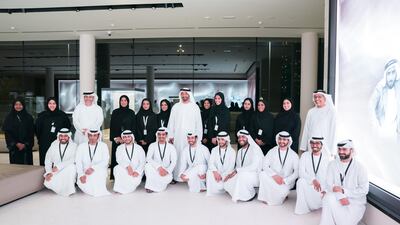 Sheikh Mohamed bin Zayed stands for a group photograph with employees during a tour of The Founders Memorial. Seen with Yusef Al Obaidly, general manager of The Founders Memorial. Hamed Al Mansoori / Ministry of Presidential Affairs