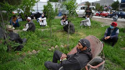 Afghan citizens wait to receive free bread from the municipality outside a bakery during Ramadan as the government imposed a nationwide lockdown to prevent the spread of the coronavirus. AFP.