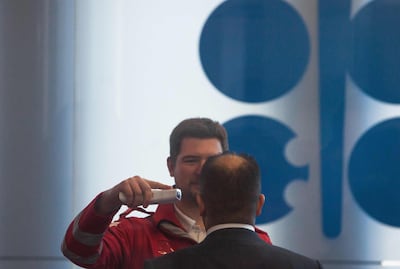 A Red Cross medic measures the temperature of a participant at Opec's meeting in Vienna last week. AFP