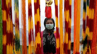 An Indian woman sells holy ropes at Sagar Island during annual fair. EPA
