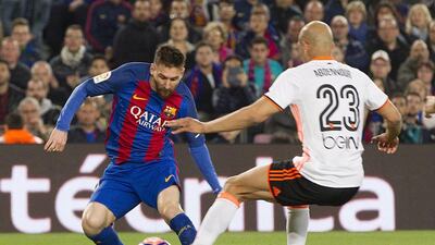Barcelona’s Argentine striker Lionel Messi, left, fights for the ball with Tunisian defender Aymen Abdennour. Marta Perez / EPA