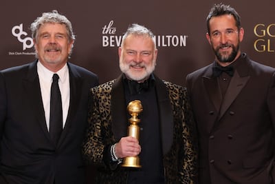 From left to right: producers John Wells and R Scott Gemmill with actor Noah Wyle with their Best Television Series - Drama award for The Pitt. AFP