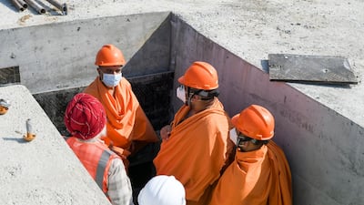 Head priests will remain on-site throughout much of the work to guide the builders. Khushnum Bhandari for The National