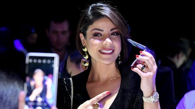 A member of the media poses for a photo with a Samsung Galaxy Z Flip phone display during the Samsung Galaxy Unpacked 2020 event in San Francisco, California. AFP