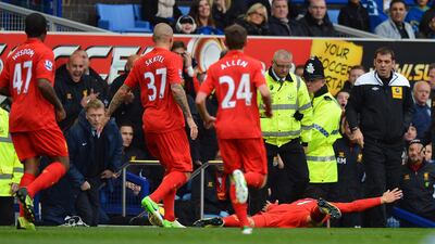 October 28, 2012: Suarez celebrated a goal for Liverpool against bitter rivals Everton by diving in front of then Toffees manager David Moyes, who had earlier claimed that ''divers'' such as Suarez were putting fans off the English game. AFP