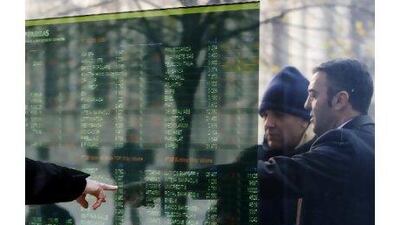 Stock prices are displayed in Milan. Italy's new government last week announced far-reaching reforms in response to a European debt crisis that pushed borrowing costs for France and Spain sharply higher, and brought tens of thousands of Greeks on to the streets of Athens.