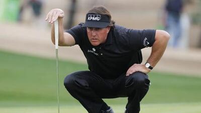 Phil Mickelson lines up a putt on his way to victory in the Phoenix Open.