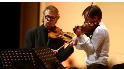 Augustin Dumay, left, performs and conducts Mozart Masterpieces in the capital last night. Delores Johnson / The National