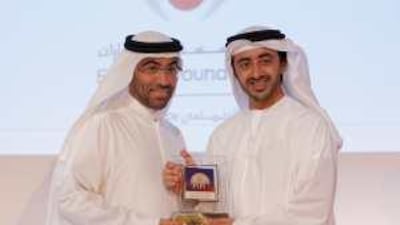 Sheikh Abdullah bin Zayed, right, the Minister of Foreign Affairs and Chairman of the Emirates Foundation, presents an award to Ahmed Al Sayegh, the chairman of Aldar Properties, during the ceremony in Abu Dhabi.