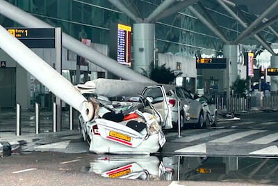 Sections of the collapsed canopy rest on vehicles outside Delhi airport's Terminal 1. AP Photo