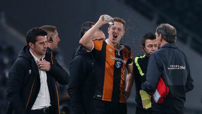 Hull City's Michael Dawson receives medical attention after sustaining an injury while Hull City manager Marco Silva looks on. Scott Heppell / Reuters