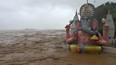 Water from the overflowing river Tawi floods a temple of the Hindu elephant god Ganesh during heavy rains in Jammu on September 6, 2014. Authorities declared a disaster alert in the northern region after heavy rain hit villages across the Kashmir valley, causing the worst flooding in two decades. Mukesh Gupta / Reuters