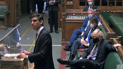 Britain's Prime Minister Boris Johnson watching as Rishi Sunak delivers his Budget statement. AFP