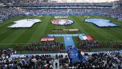 Teams stand for the national anthems prior to the start of the match. Michael Sohn / AP Photo