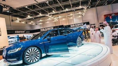 A man photographs a Lincoln Continental on the opening night of the Dubai International Motor Show. Alex Atack for The National