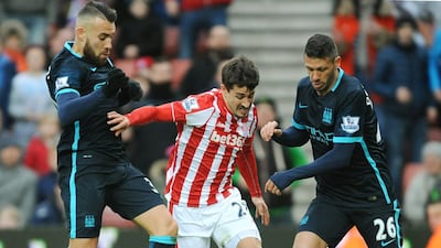Stoke’s Philipp Wollscheid, centre, is tackled by Manchester City’s Martin Demichelis, right, and Nicolas Otamendi, left, during the English Premier League soccer match between Stoke City and Manchester City at the Britannia Stadium, Stoke on Trent, England, Saturday, Dec. 5, 2015. (AP Photo/Rui Vieira)