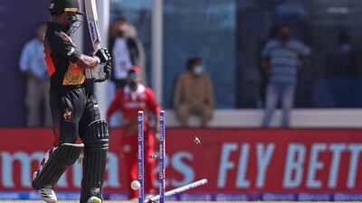 Papua New Guinea's Lega Siaka is clean bowled by Oman's Kaleemullah. AFP