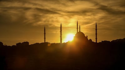The sun rises behind the Camlica Mosque in Istanbul. AP Photo