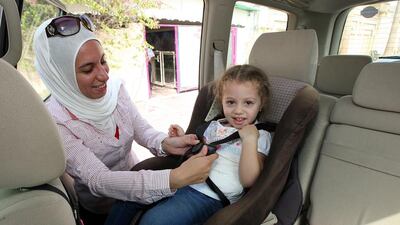 Parents have applauded a change in the UAE traffic laws which penalises drivers if their passengers are not wearing seat belts and if children are not sitting in child seats. Pawan Singh / The National