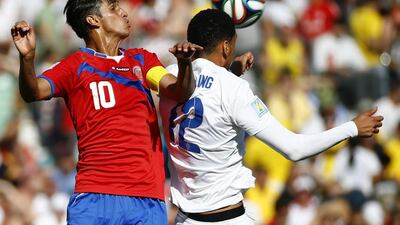 Costa Rica's Bryan Ruiz, left, jumps for the ball with England's Chris Smalling during their 2014 World Cup Group D match on Tuesday in Belo Horizonte, Brazil. Murad Sezer / Reuters