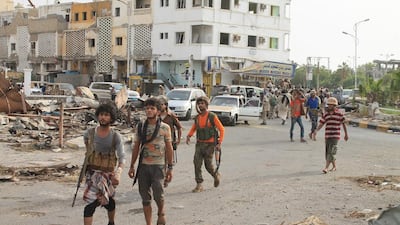 Fighters against Shiite rebels known as Houthis gather at a street in the port city of Aden. Abo Muhammed / AP Photo
