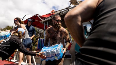 Volunteers load supplies on to a boat bound for West Maui at the Kihei boat landing. AP