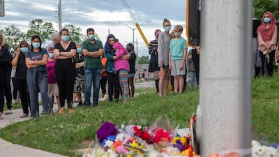 People attend at a memorial at the location where a family of five was hit by a driver, in London, Ontario on Monday. AP Photo
