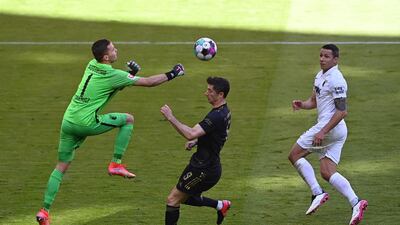 Augsburg's goalkeeper Rafal Gikiewicz against Robert Lewandowski. EPA