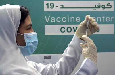 A Saudi physician prepares to inject the Pfizer vaccine at a coronavirus vaccination centre at Jeddah's old airport. AP