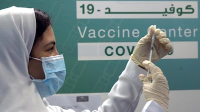 A Saudi physician prepares to inject thePfizer-BioNTech vaccine at a coronavirus vaccination centre at Jeddah's old airport. AP