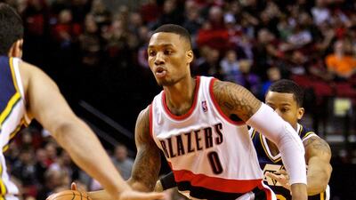 Portland Trail Blazers point guard Damian Lillard, centre, drives to the basket during the first quarter against the Utah Jazz at the Moda Center on February 25, 2014. Craig Mitchelldyer / USA TODAY Sports