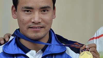 India's Jitu Rai poses with his gold medal after winning the men's 50m pistol individual final of the 2014 Asian Games in Incheon. Manan Vatsyayana / AFP