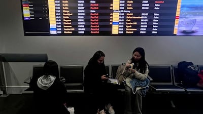Departure boards at Manchester Airport show many flights cancelled or delayed due to high winds. AFP