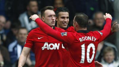 Manchester United's Phil Jones, left, celebrates with teammates after scoring a goal against West Bromwich Albion during their English Premier League match at The Hawthorns on March 8, 2014. Darren Staples / Reuters
