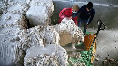 Kashmir labourers carry raw material for making silk toward a machine inside a silk factory on the outskirts of Srinagar. EPA