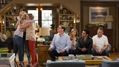 From left, Candace Cameron Bure, Jodie Sweetin, Andrea Barber, Bob Saget, Lori Loughlin, John Stamos and Dave Coulier in Fuller House. In a spin on the original Full House, the three female stars are now taking care of their young sons. Michael Yarish / courtesy Netflix