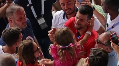 Serbia's Novak Djokovic celebrates with his family after beating Spain's Carlos Alcaraz. AFP