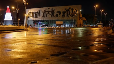 Iraqi police officers stand guard on a street after the start of a Covid-19 curfew in Baghdad. Reuters