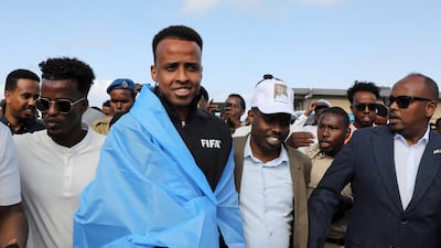 Somali referee Omar Abdulkadir Artan, who had been due to officiate at Fifa World Cup matches but was denied entry to the US, is received at Aden Abdulle Osman International Airport in Mogadishu. Reuters