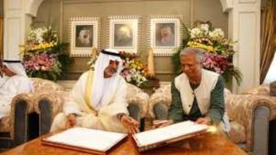Sheikh Nahyan bin Mubarak, the Minister of Higher Education and Scientific Research, signs a memorandum of understanding with Prof Muhammad Yunus.