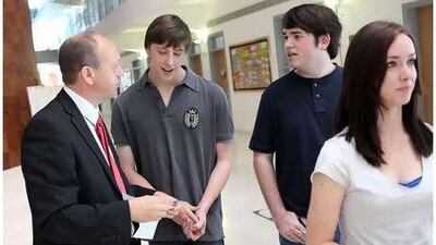 From left, the principal Paul Coackley discusses the results of Josh Swindling's and Alex Wallace's A level test.