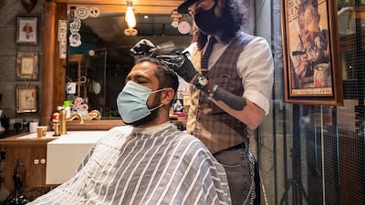 Barbers at Möto Barber in Al Quoz. Antonie Robertson/The National