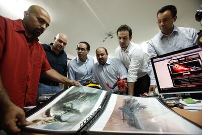 Suleiman Bakhit (L) discusses his work with (from L to R): Afif Toukan, Mohammad Haj Hasan, Muhannad Ebwini, Suhaib Thiab and Nour Khrais, at his office in Amman, Jordan on June 08, 2010. Photo: Salah Malkawi for The National